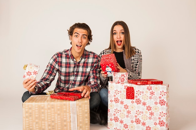 Surprised couple with present boxes