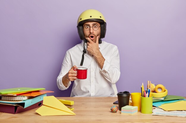 Surprised employee sitting at the office desk