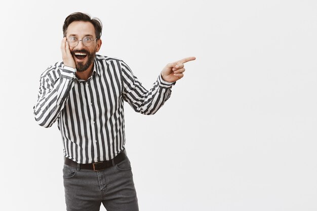 Surprised and excited bearded mature man posing