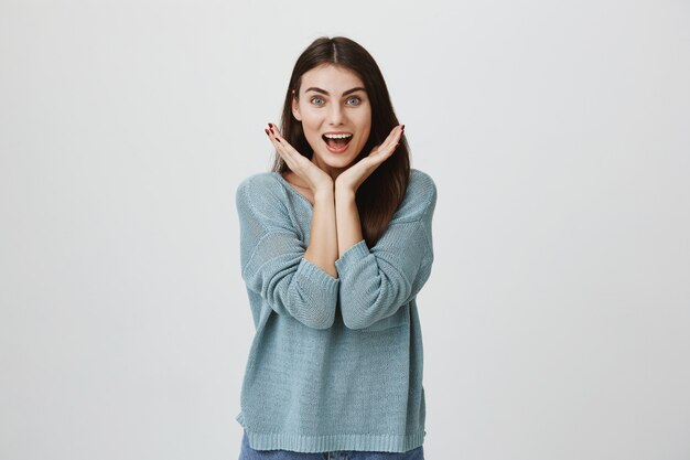 Surprised and excited woman smiling astonished