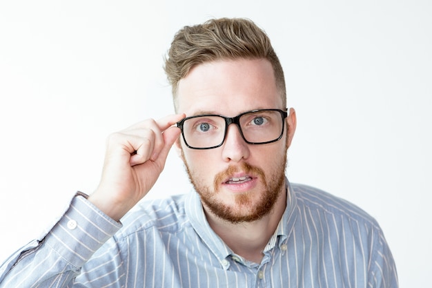 Surprised face of man looking through glasses