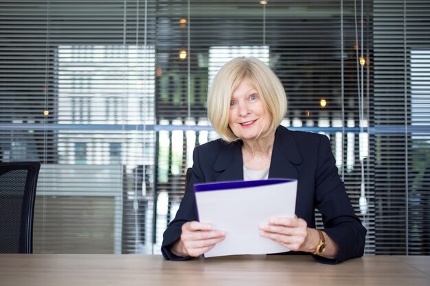 Surprised female executive sitting in board room