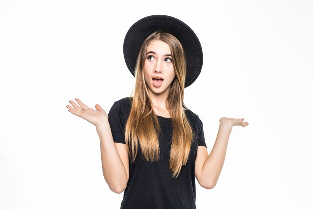 Surprised girl with gold hair holds her arms on both sides isolated on white