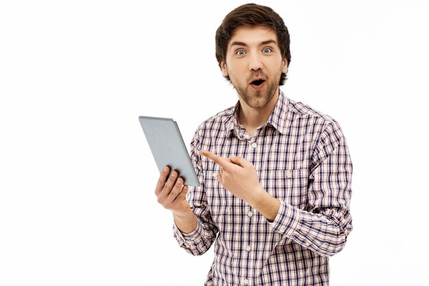 Surprised guy pointing tablet screen, say wow