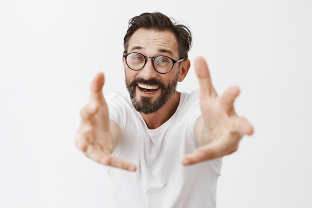 Surprised and happy bearded mature man with glasses posing