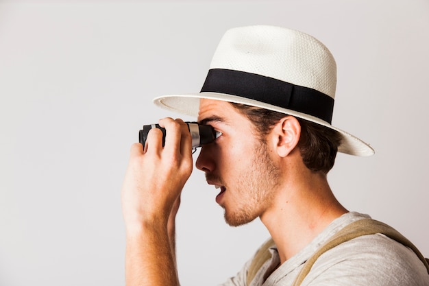 Surprised hipster man with binoculars