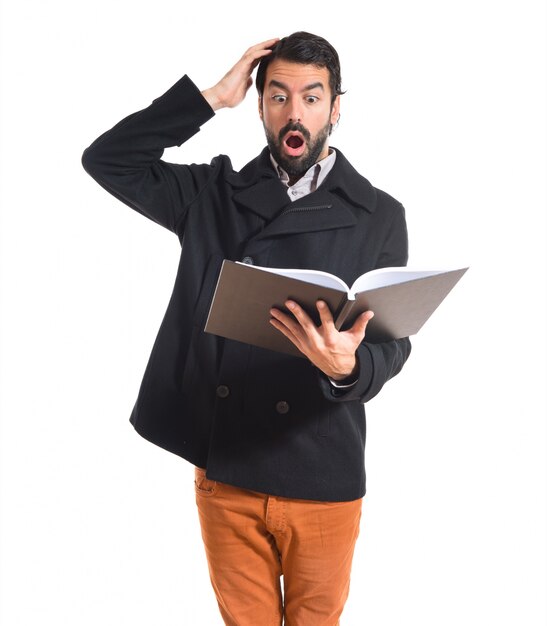 Surprised man reading book