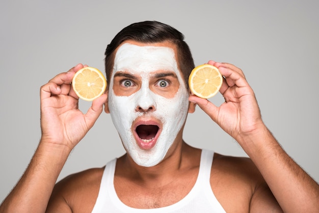 Surprised man with face mask and lemon