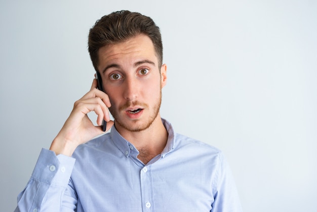 Surprised manager overwhelmed with phone call