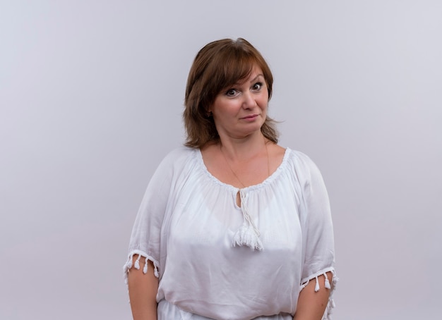 Surprised middle-aged woman looking on isolated white wall