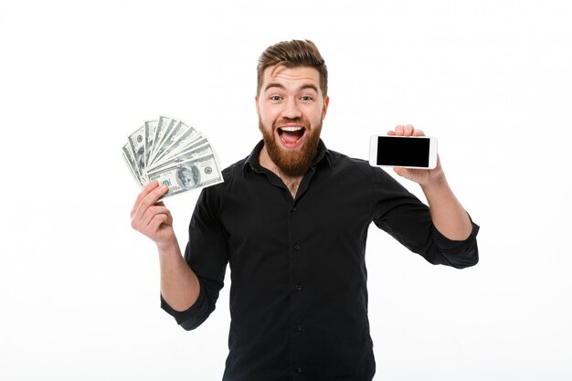 Surprised pleased bearded business man in shirt holding money