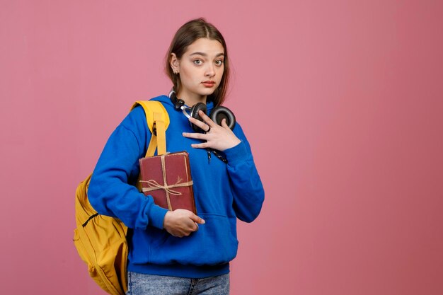 Surprised schoolgirl standing looking at camera