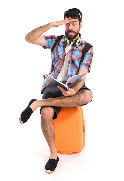 Free photo surprised tourist reading book