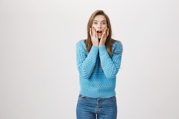 Surprised woman drop jaw gossiping