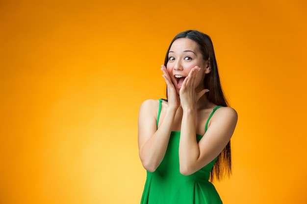 Surprised woman in green dress