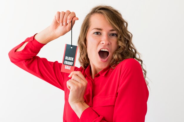 Surprised woman holding black friday label