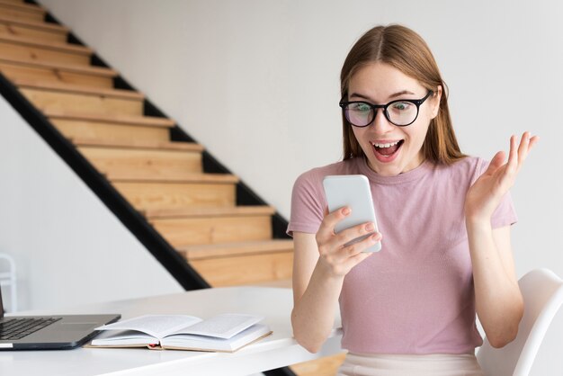 Surprised woman looking at her phone