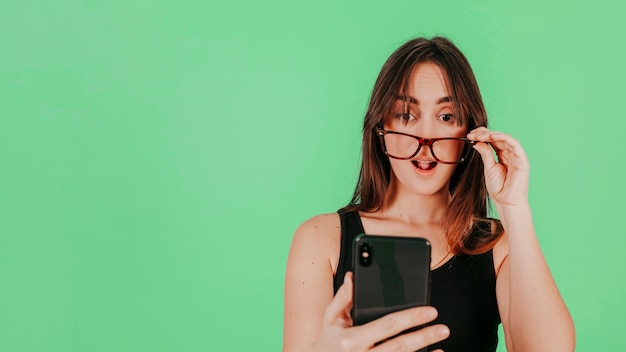 Surprised woman looking at smartphone