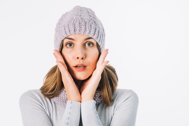 Surprised woman in scarf and hat