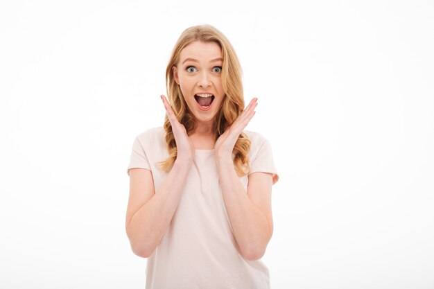 Surprised woman standing isolated