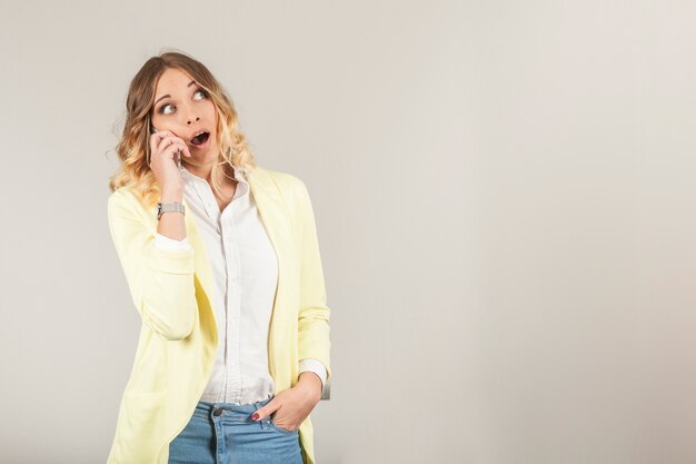 Surprised woman talking on phone