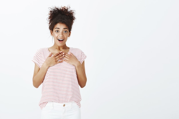 Free photo surprised woman with afro hairstyle posing in the studio