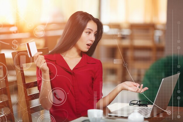 Surprised woman with a card in hand