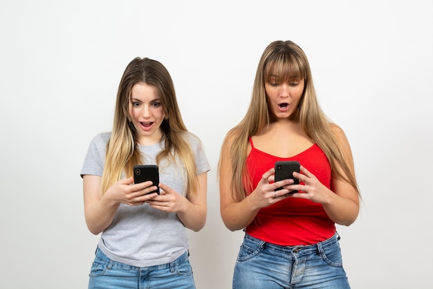 Surprised women holding phone