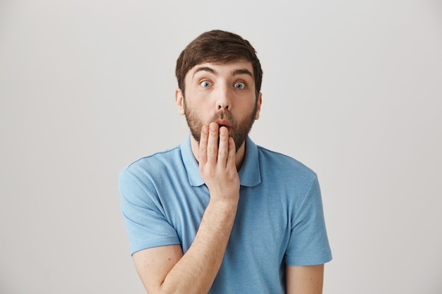 Surprised young bearded man posing