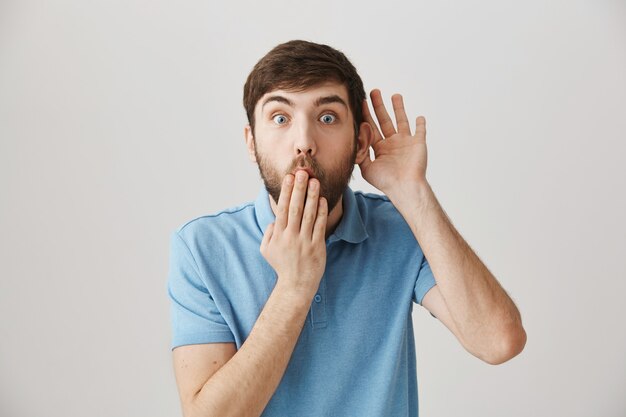 Surprised young bearded man posing