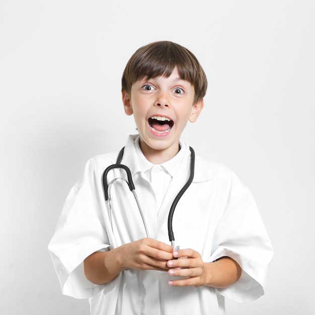 Surprised young boy with stethoscope