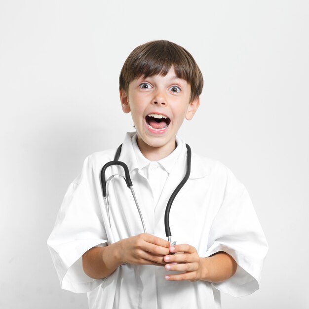 Surprised young boy with stethoscope