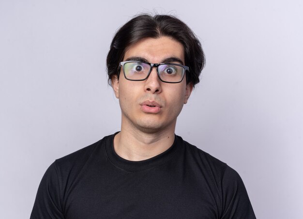 Surprised young handsome guy wearing black t-shirt and glasses isolated on white wall