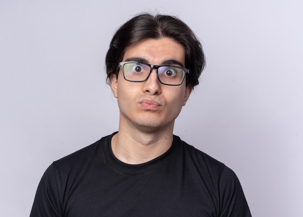 Surprised young handsome guy wearing black t-shirt and glasses isolated on white wall