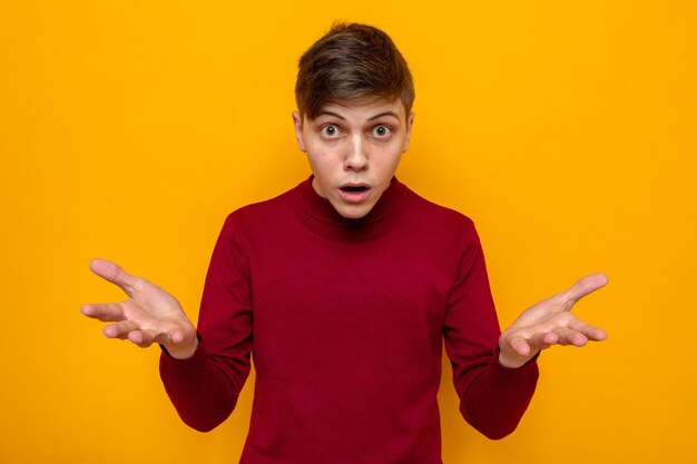 Surprised young handsome guy wearing red sweater