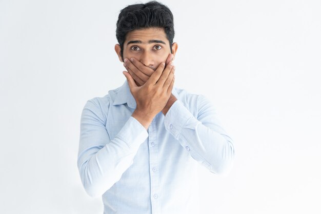 Surprised young man learning unexpected news.