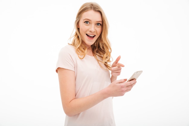 Surprised young woman using mobile phone.