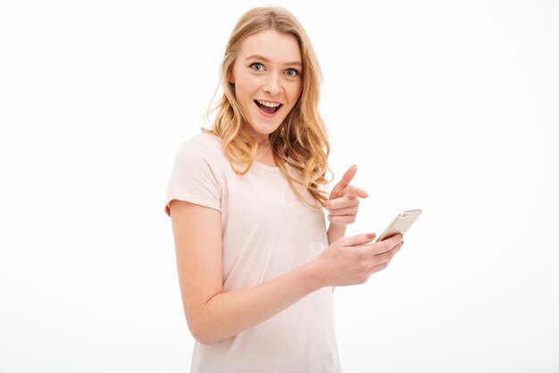 Surprised young woman using mobile phone.