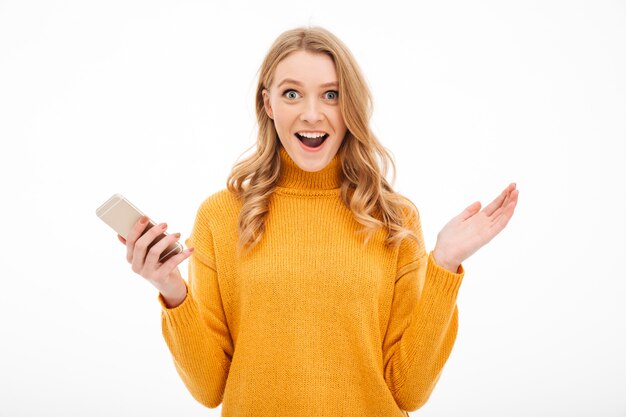 Surprised young woman using mobile phone.