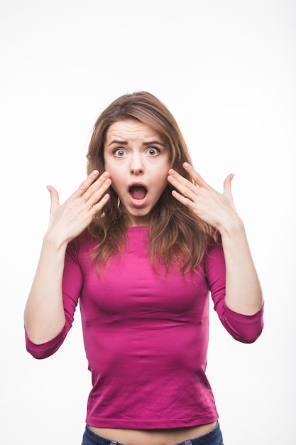 Surprised young woman with her mouth open on white background