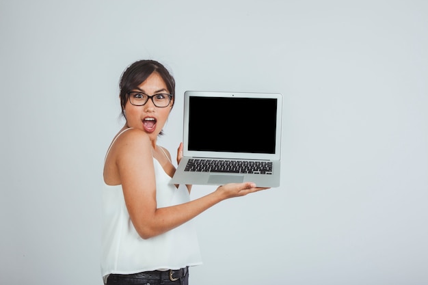 Surprised young woman with laptop