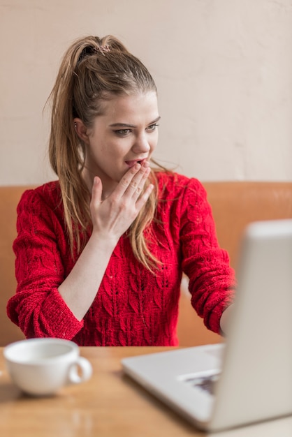 Surprised young woman working