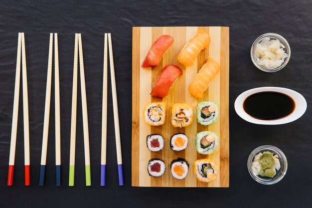 Sushi among chopsticks and condiments