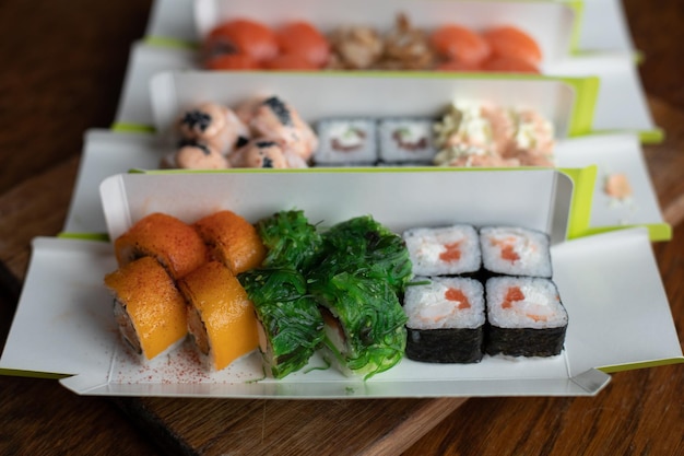 Free photo sushi for delivery top view of rolls with fish on the background