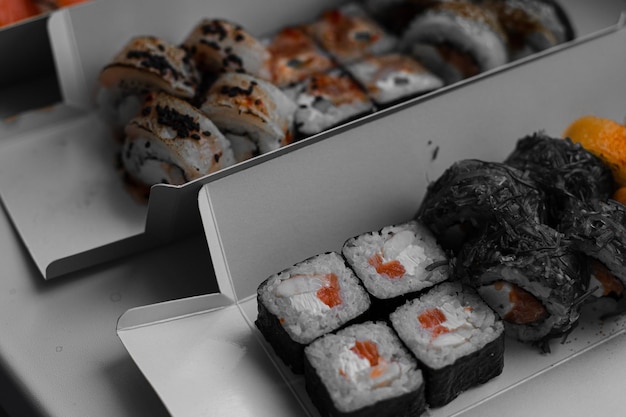 Free photo sushi in different forms a variety of sushi rolls for delivery