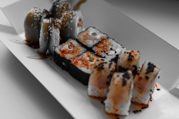 Sushi of different types on a wooden stand delivery lunch dinner