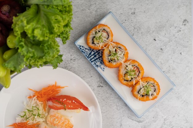 Sushi is beautifully arranged on the plate.