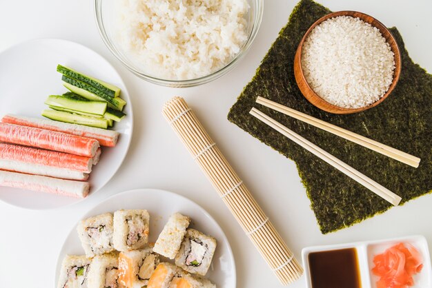 Sushi mat surrounded by ingredients