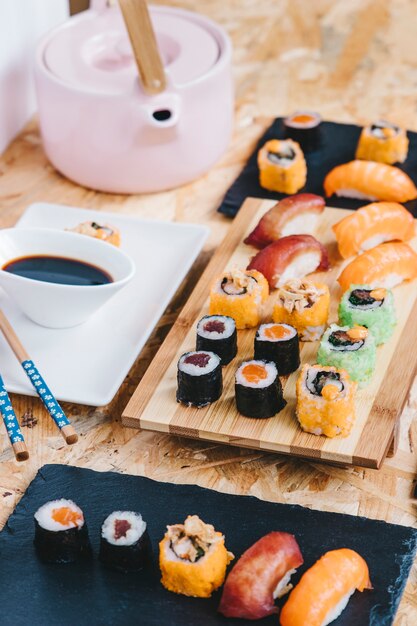 Sushi near soy sauce and teapot
