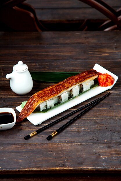 Sushi rolls covered with fried fish fillet